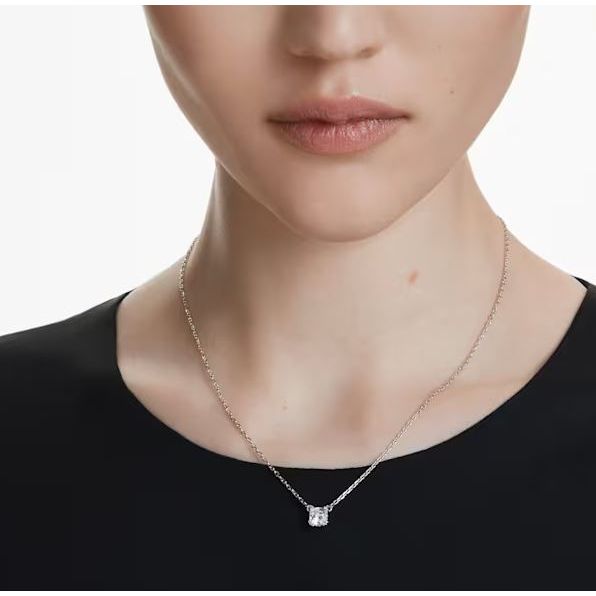 Woman wearing elegant Swarovski necklace with a silver chain, perfect jewelry accessory for formal occasions.