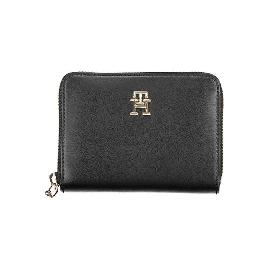 Tommy Hilfiger black polyethylene women's wallet with logo and zip closure, featuring five compartments and card spaces.