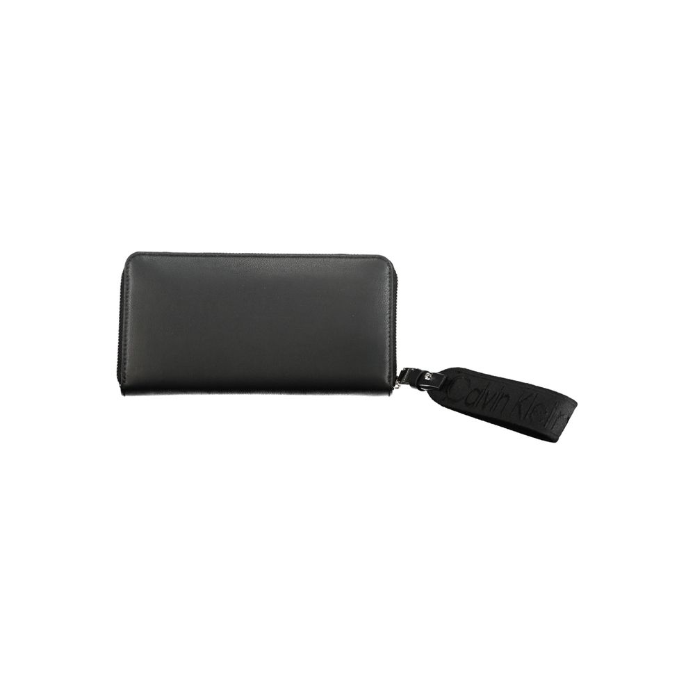 Calvin Klein Black Polyethylene Wallet with zip closure and removable pull, featuring 5 compartments, coin purse, and card spaces.