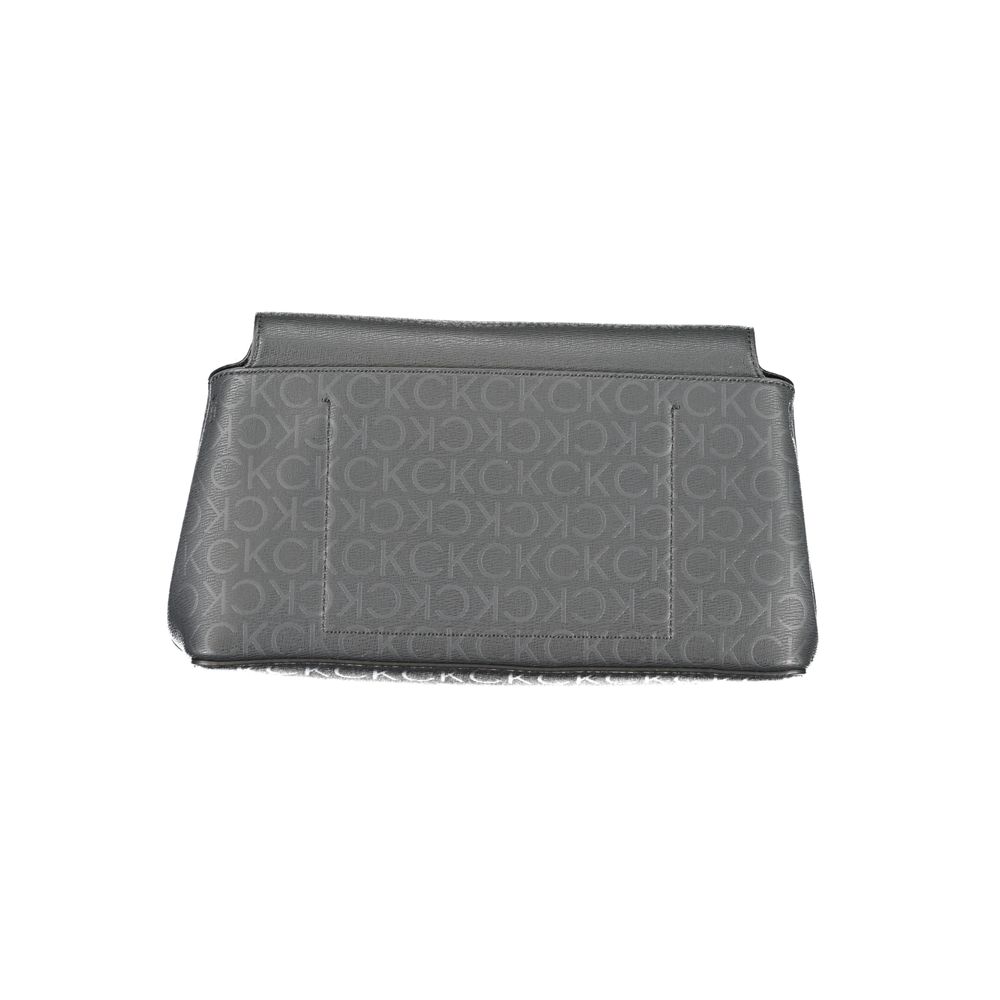 Calvin Klein Black Polyester Handbag with adjustable shoulder strap and internal pocket. Features contrasting details and snap closure.