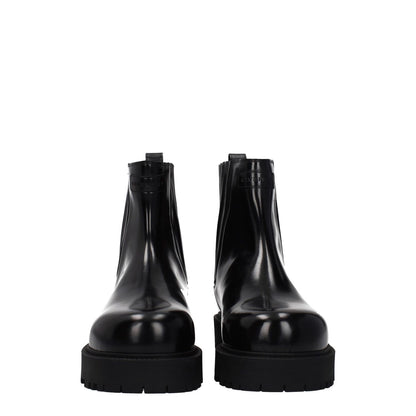 Givenchy Black Leather Ankle Boots with front and back logo, featuring a rubber sole and round toe design.