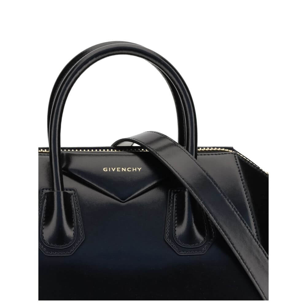 Givenchy Black Calf Leather Bos Taurus Handbag with gold embossed signature, zipper closure, and adjustable shoulder strap.
