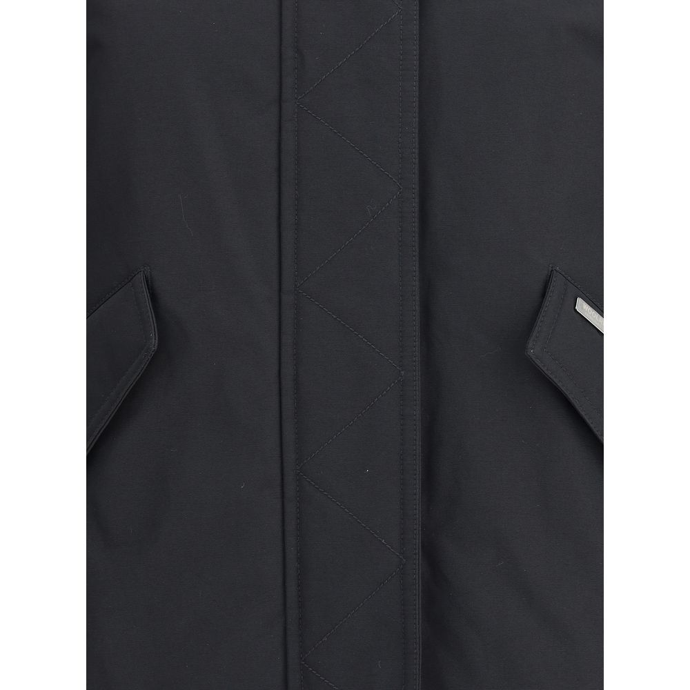 Close-up of Woolrich Black Cotton Shell Jacket showing front closure and welt pockets with flaps for winter AW25 season.