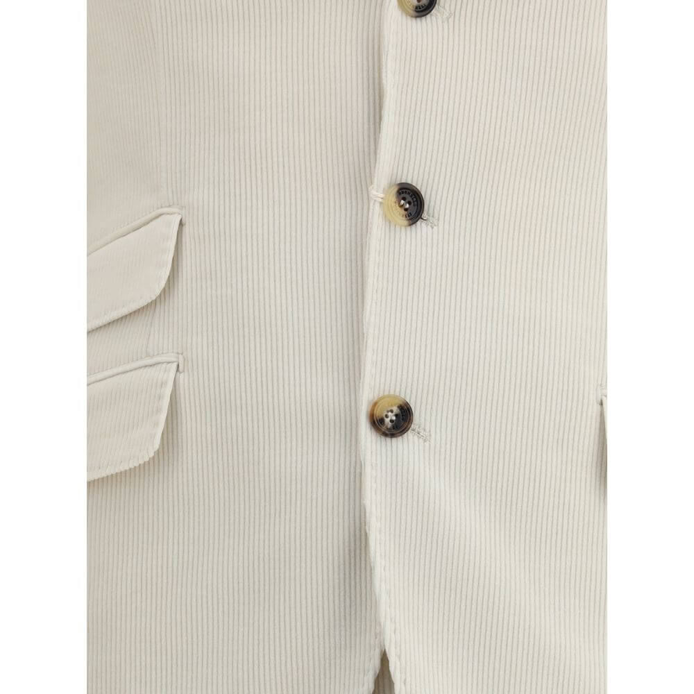 Close-up of Brunello Cucinelli Cream Cotton Two-Piece Suit blazer showing button details and pocket design.