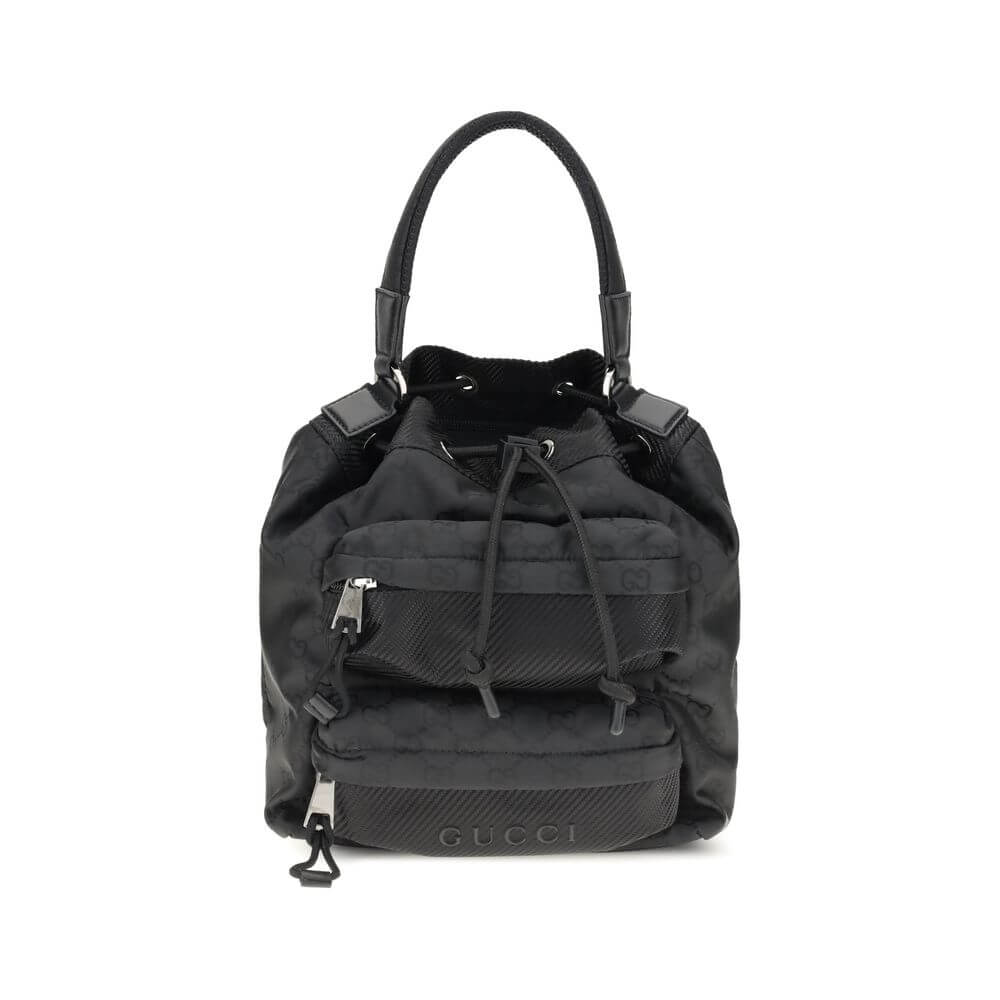 Gucci Black Polyamide Backet Bag with GG Supreme pattern, drawstring closure, and zippered pockets for functional organization, AW25 season.