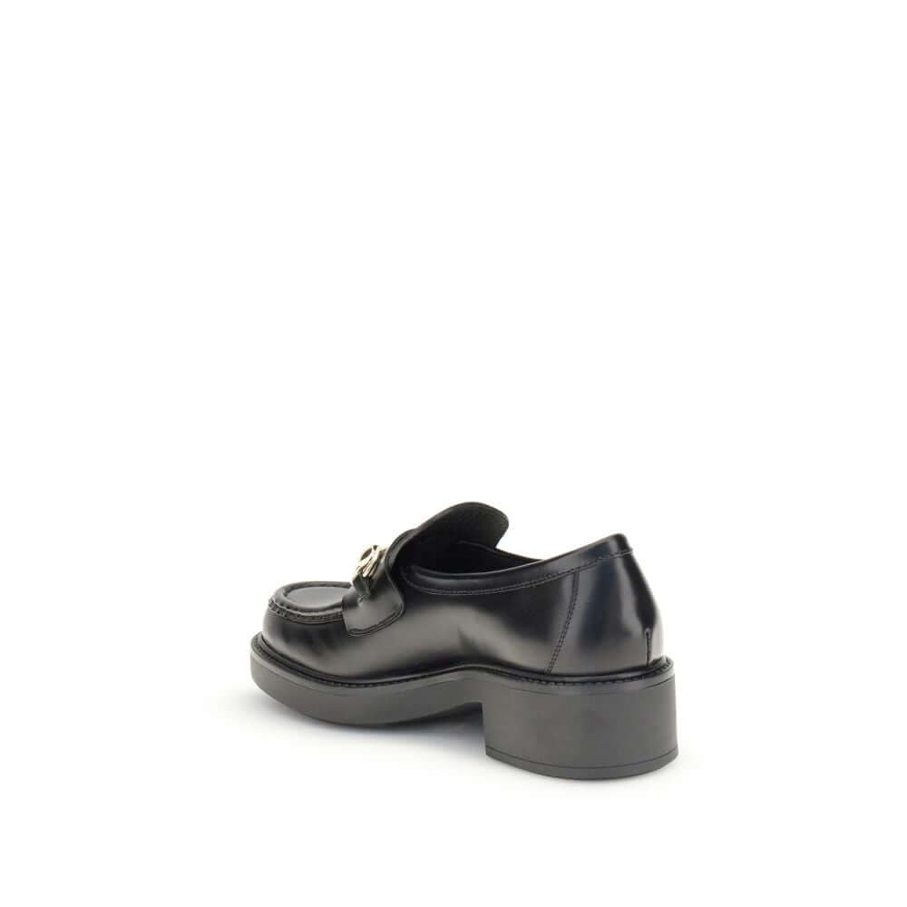 Gucci Black Calf Leather Bos Taurus Slip-On Loafers with horsebit detail and block heel, side view.