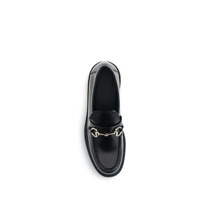 Gucci Black Calf Leather Bos Taurus Slip-On Loafers with iconic horsebit detail, round toe, and block heel, top view.