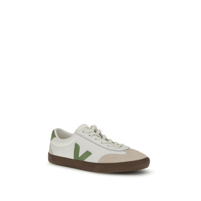 Veja White Leather Low Top Sneakers with green logo, inspired by 1970s Brazilian volleyball shoes, featuring a flat sole and sustainable design.