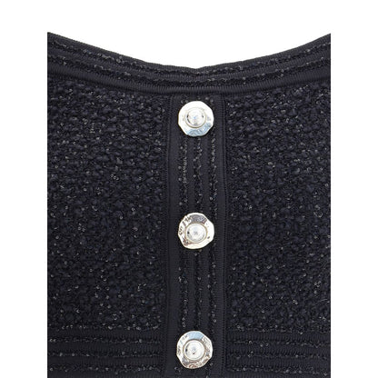 Detailed view of Balmain Black Polyamide Top's tweed texture and embossed button closure showcasing elegant design.