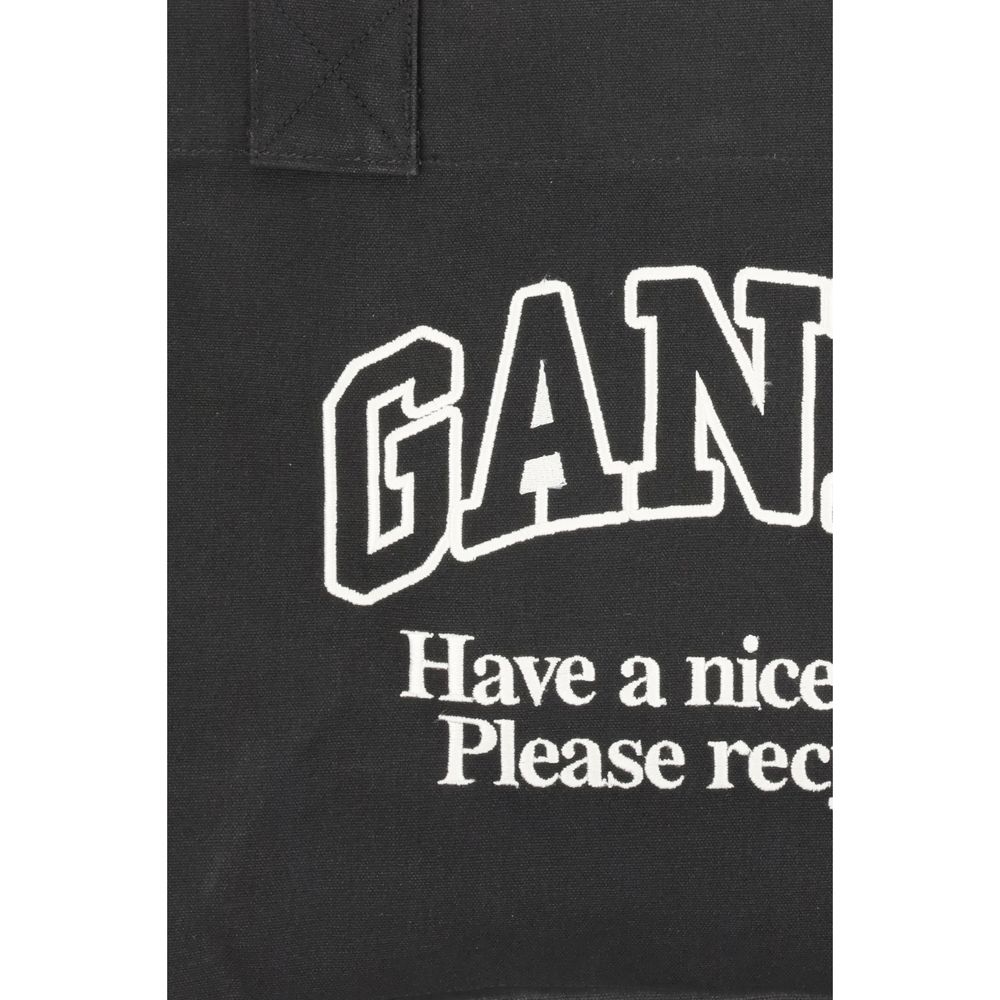 Ganni Black Cotton Shoulder Bag featuring logo and sustainability message "Have a Nice Day! Please Recycle", made with recycled cotton.