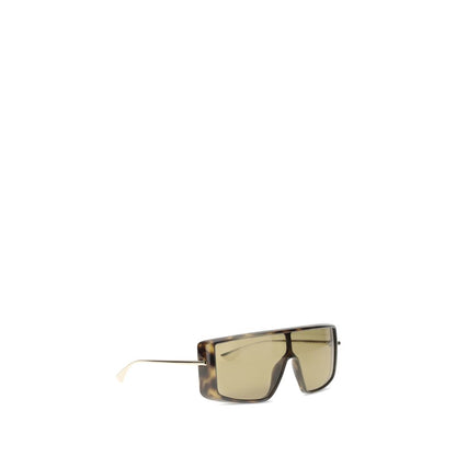 Alexander McQueen Brown Acetate Sunglasses with tortoiseshell frame and gold-tone T-Bar temples on white background.