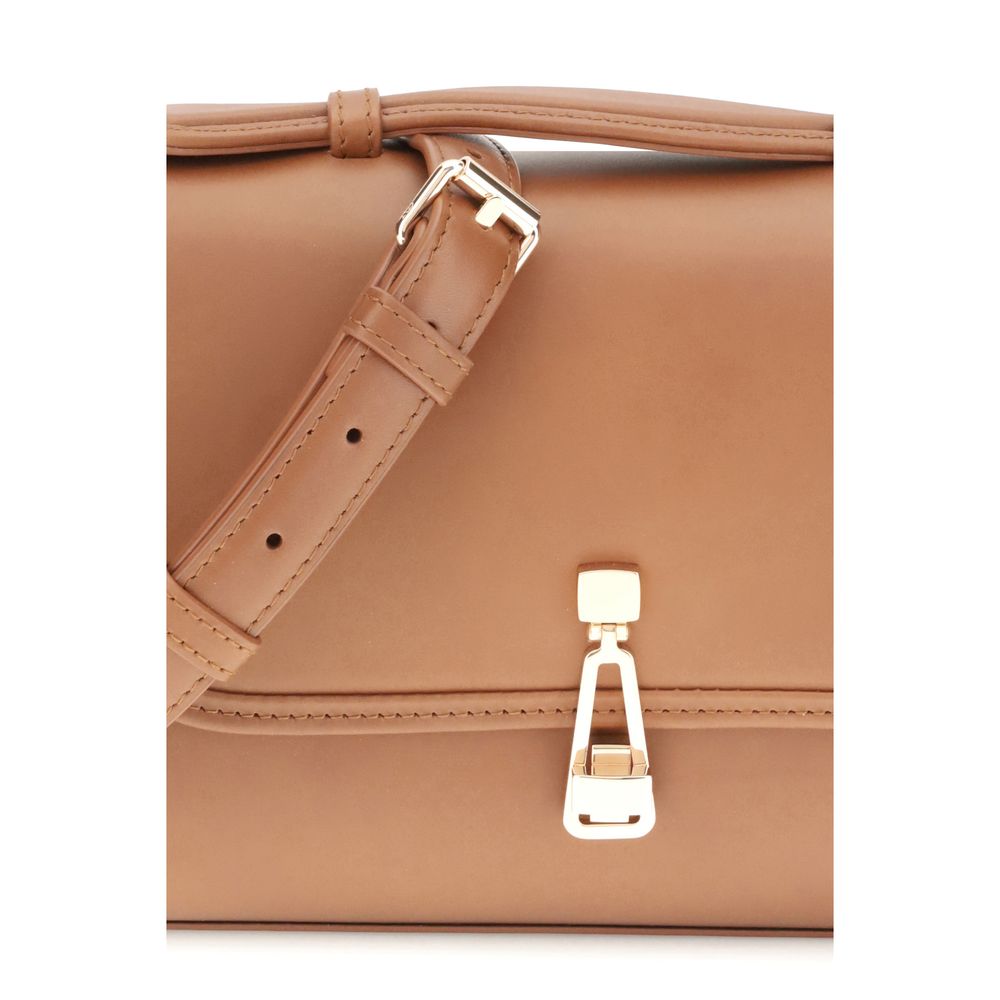Close-up of Gabriela Hearst Brown Leather Shoulder Bag with a gold clasp and adjustable leather strap, featuring intricate stitching details.