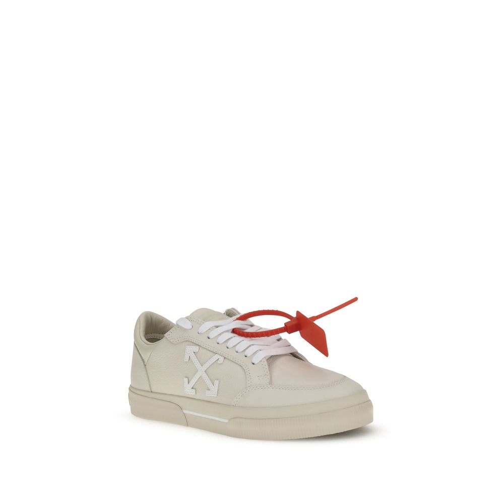 Off-White Beige Leather Low Top Sneakers with arrow motif and red zip tie tag on vulcanized rubber sole.