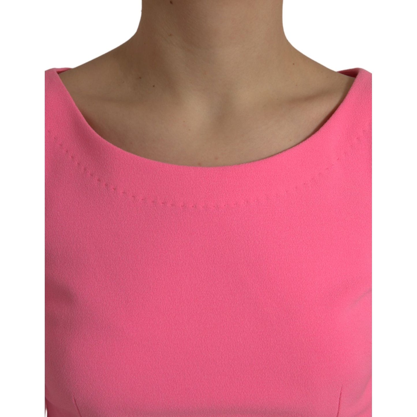 Close-up of Dolce & Gabbana Pink Polyester Long Sleeves Sheath Midi Dress neckline, showcasing the smooth fabric and vibrant color.
