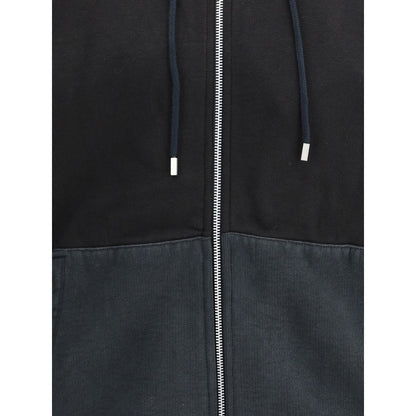 Close-up of Our Legacy Black Cotton Sweatshirt showing drawstring hood and two-way zip detail