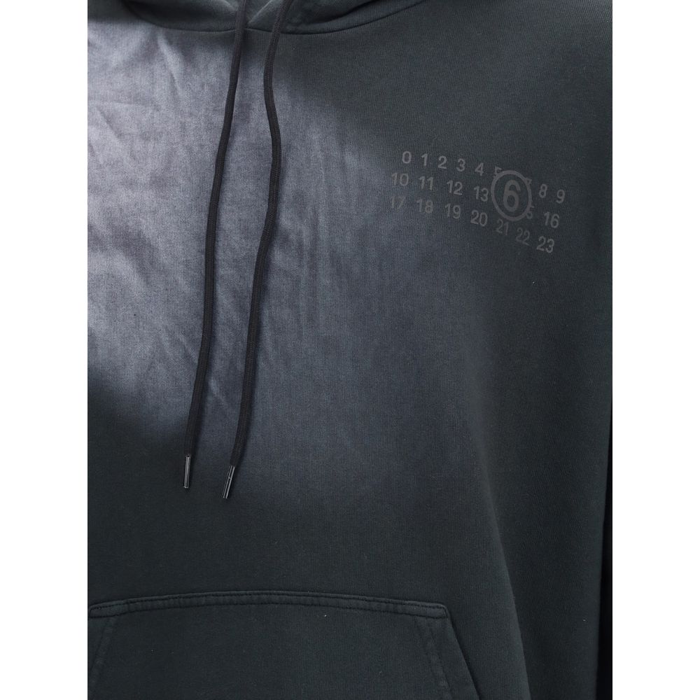 MM6 Black Cotton Sweatshirt with hood, kangaroo pocket, and relaxed fit for AW25. Made from 100% Cotton for stylish comfort and versatility.