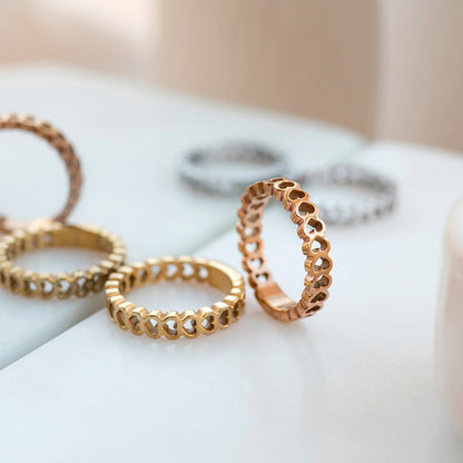 AN JEWELS JEWELRY Mod. AL.RSC01SYR-7 rings displayed on a marble surface, showcasing gold and silver tones.