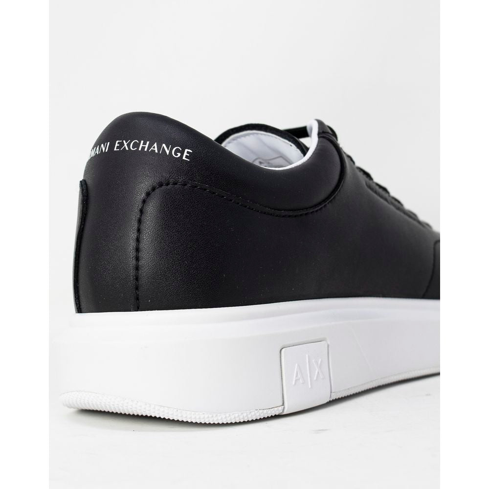 Armani Exchange Black Leather Sneaker with embossed logo and contrasting heel insert. View of side and sole with AX branding.