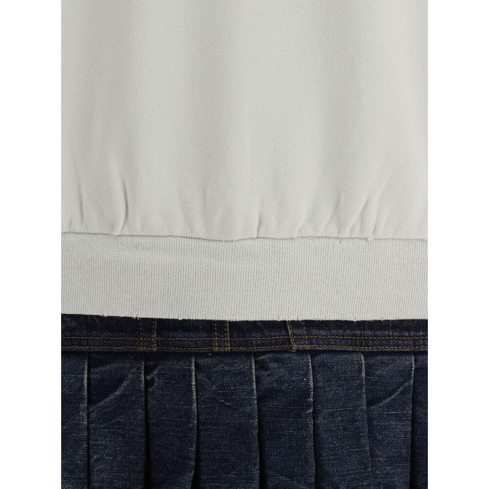 Close-up of Balenciaga Multicolor Cotton Sweatshirt with denim pleated skirt and ribbed hem detailing.
