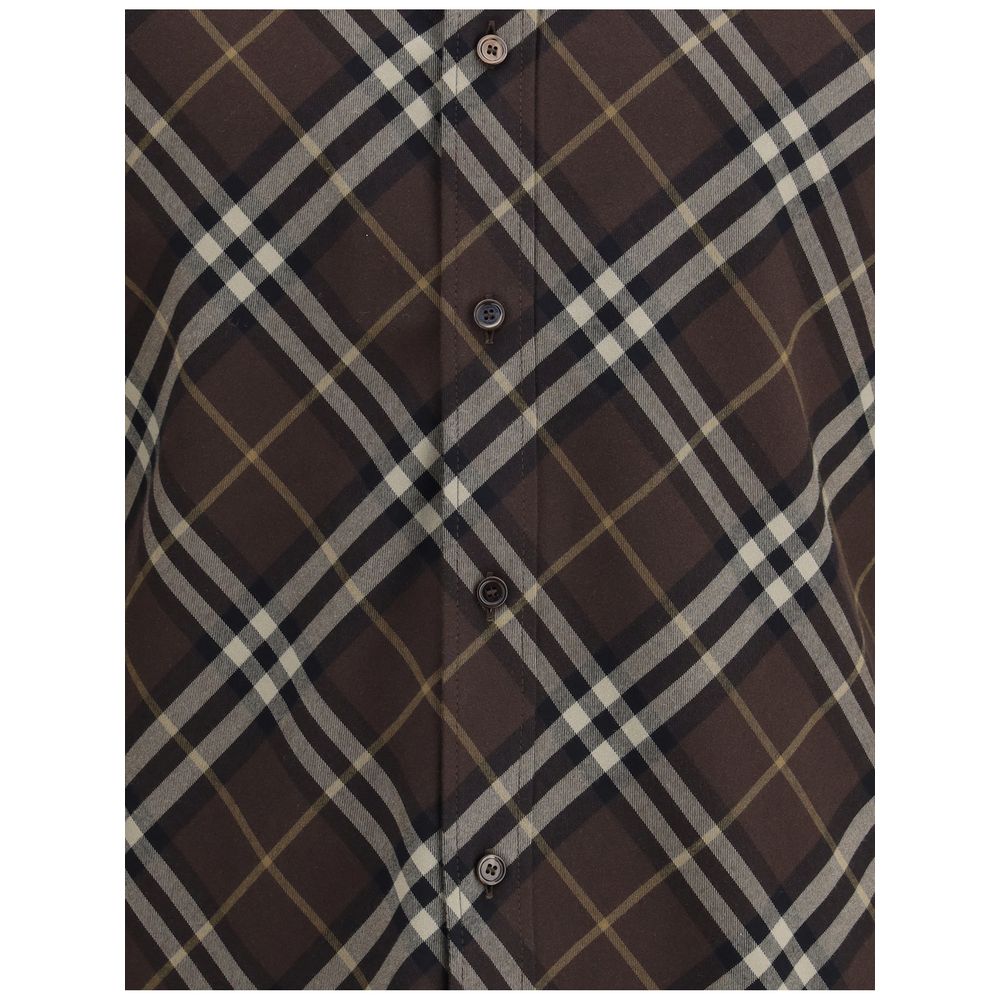Close-up of Burberry Brown Cotton Pattern Shirt featuring classic check design, button-down front, and soft flannel material.