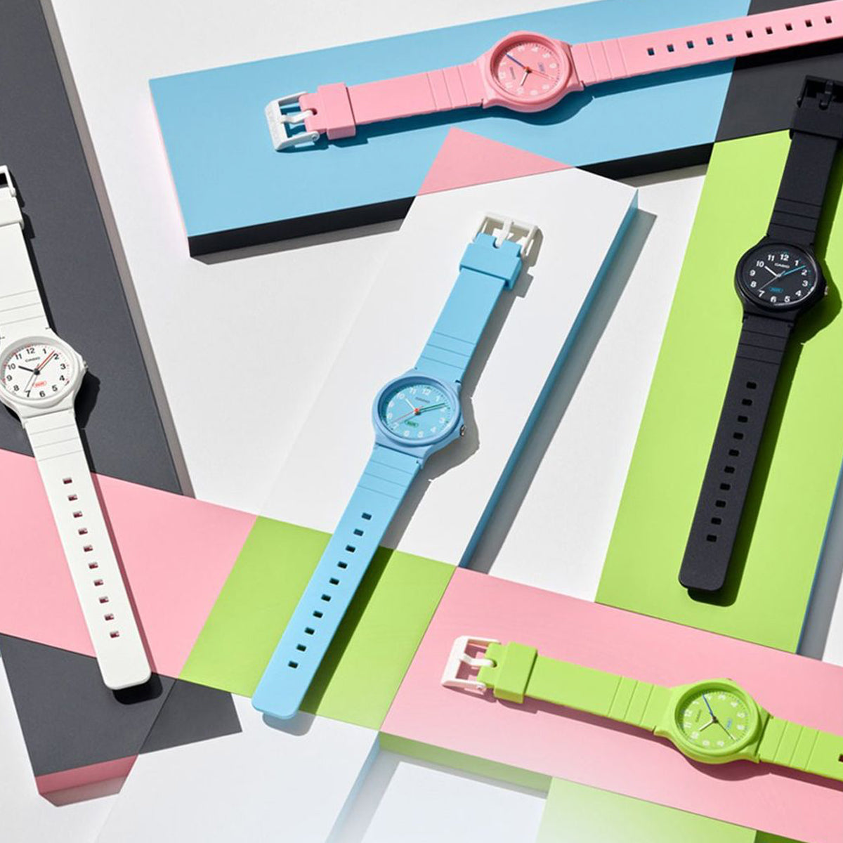 Colorful wristwatches from CASIO TIMELESS COLLECTION Mod. POP - BIO RESIN STRAP - WHITE displayed on geometric backgrounds.