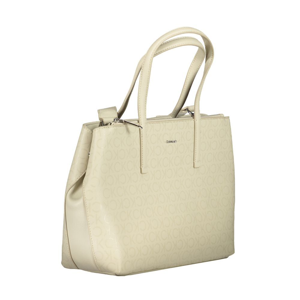 Calvin Klein Beige Polyester Handbag with dual handles, adjustable shoulder strap, and external pocket.