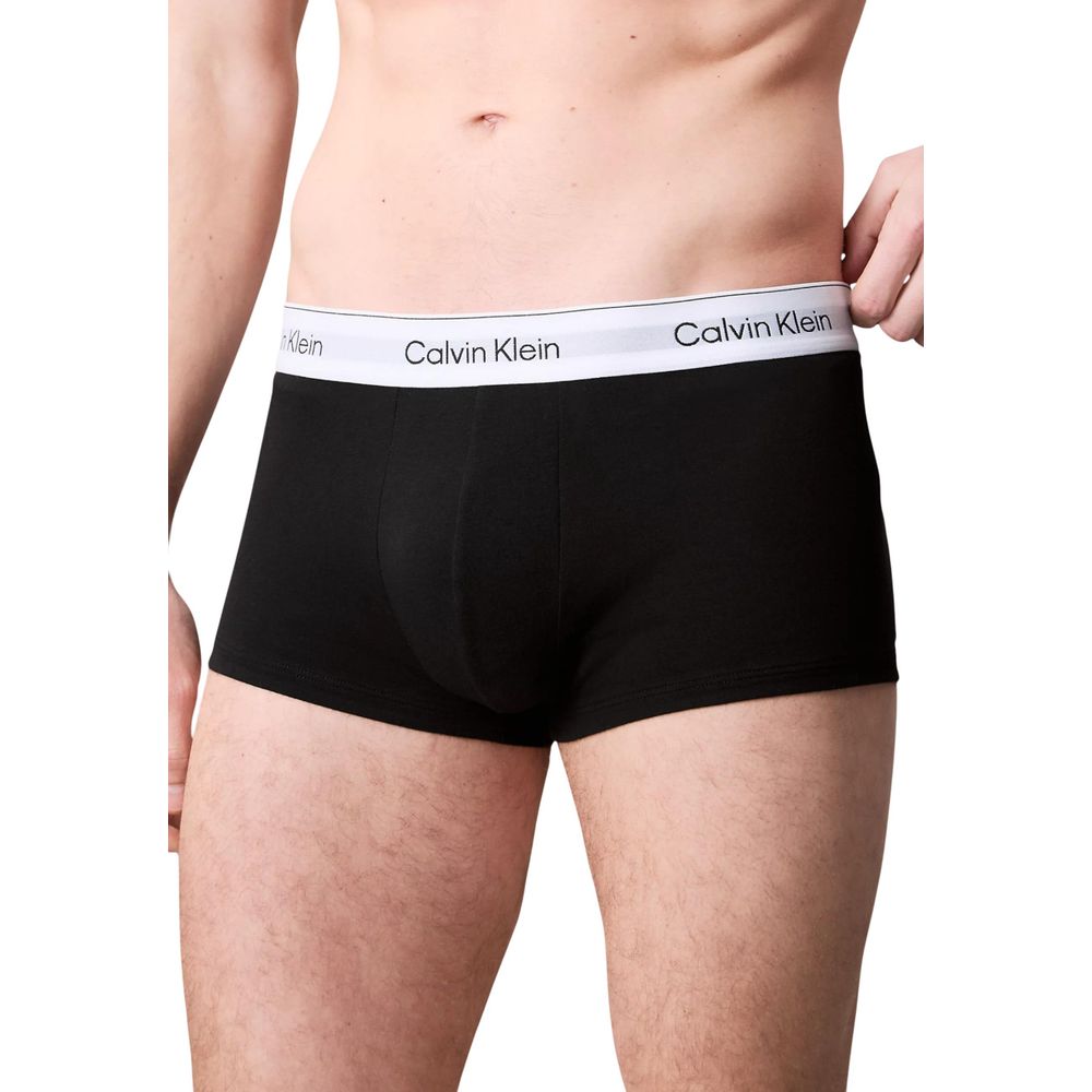 Man wearing Calvin Klein Underwear Black Cotton Boxer with logo waistband, emphasizing comfort and style.