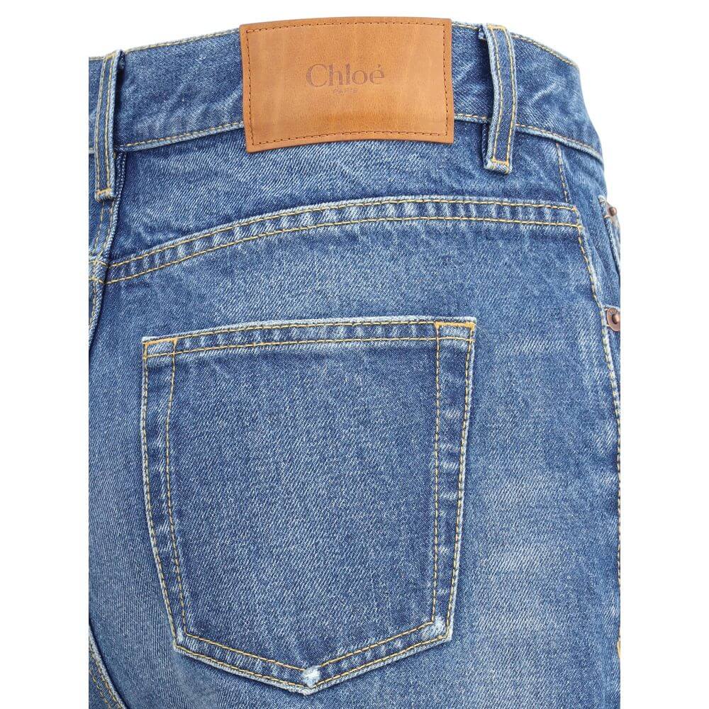 Close-up of Chloé Blue Cotton Flared Jeans with detailed stitching and tan leather patch on the back waistband.