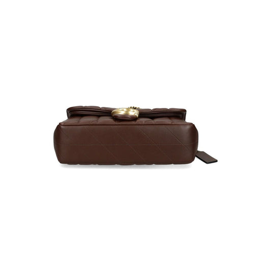 Coach Tabby 26 Shoulder Bag in chestnut brown quilted nappa leather, side view showcasing logo plaque and magnetic fastening.