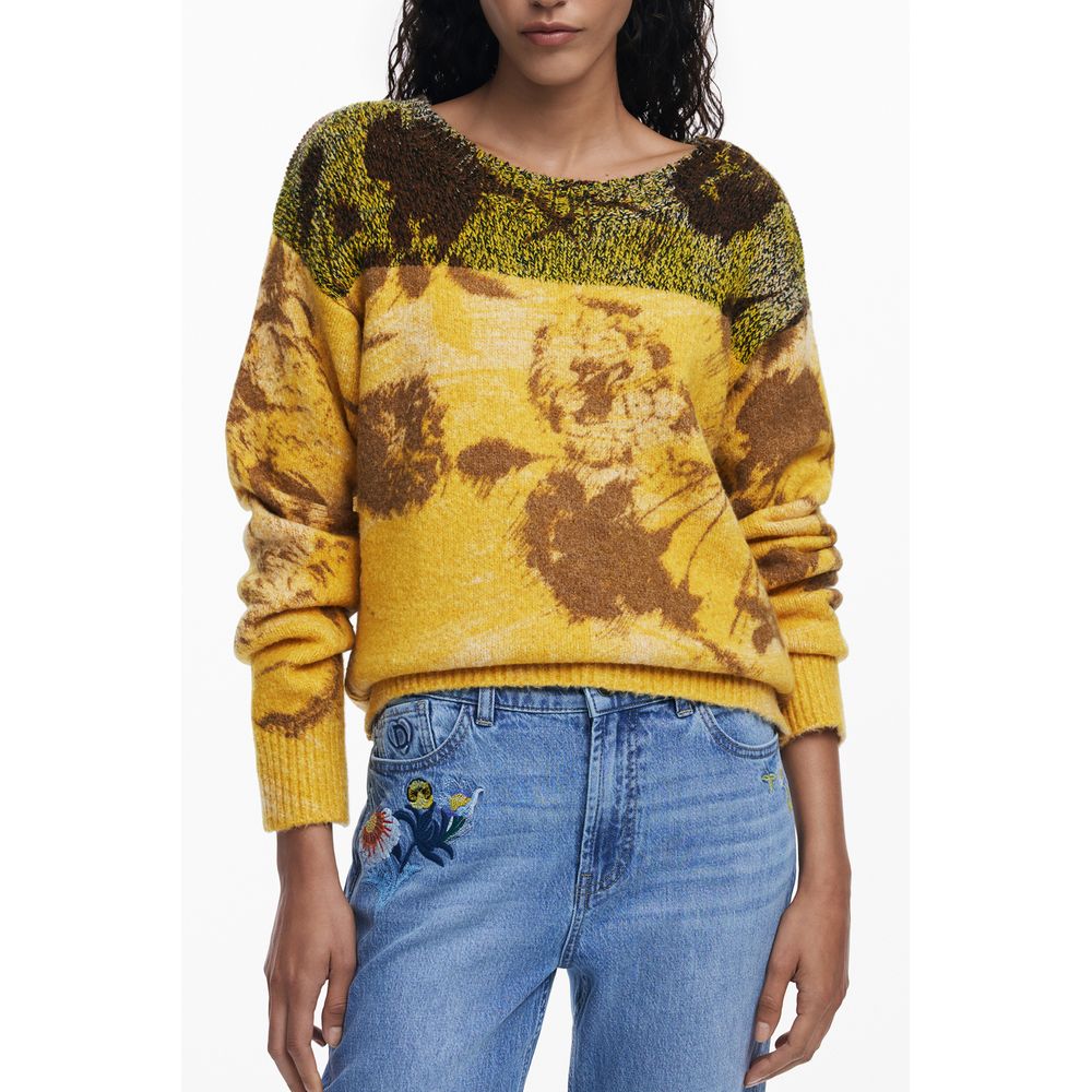 Model wearing Desigual Yellow Wool Women Sweater, featuring vibrant floral patterns and crew neck, paired with blue jeans.