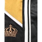 Close-up of Dolce & Gabbana Black Gold Satin Crown Side Stripe Jogger Pants with crown embroidery and gold stripe.