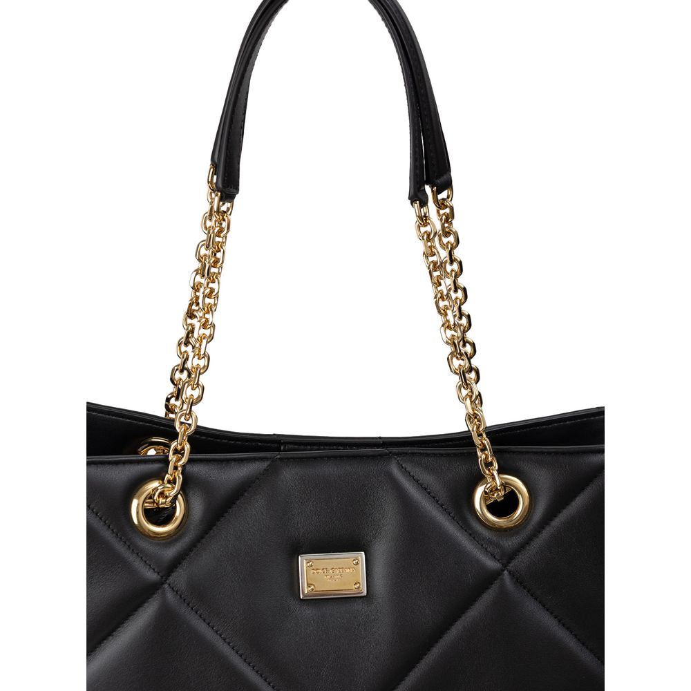 Dolce & Gabbana Black Leather Matelassé Tote Bag with gold chain handles and logo tag, featuring snap closure and internal pockets.