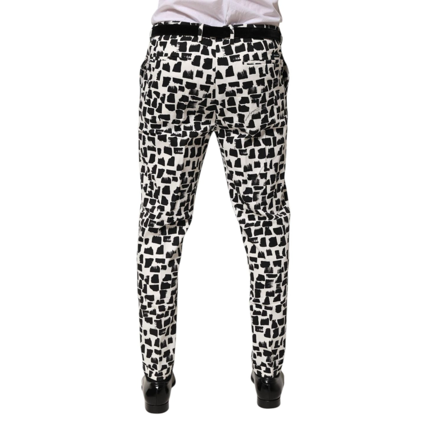 Back view of Dolce & Gabbana Black White Abstract Print Cotton Blend Pants with tailored fit and artistic design.