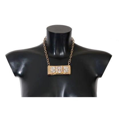 Dolce & Gabbana Gold Brass Necklace with crystal embellishments and bow motif on black mannequin bust, elegant Italian design.