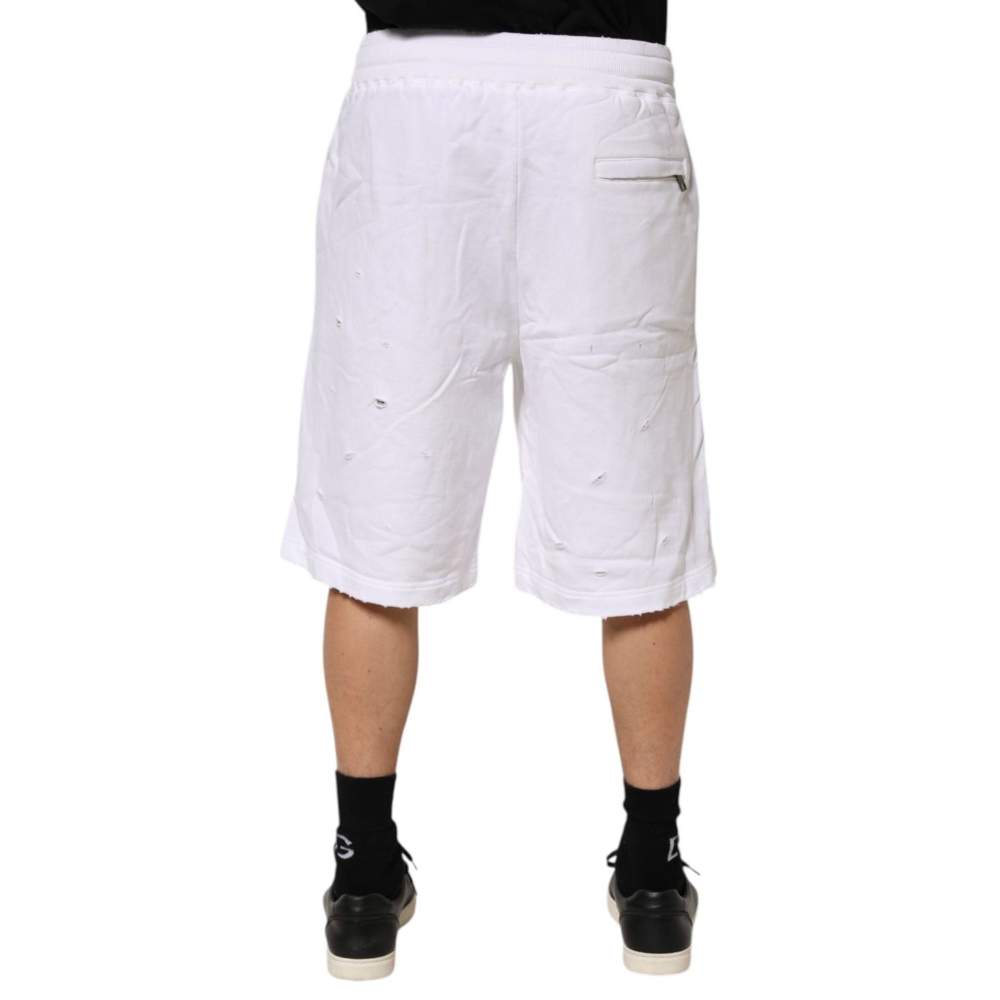 Model wearing Dolce & Gabbana White Ripped Mid Waist Casual Bermuda Short, showcasing back view and ripped style details.