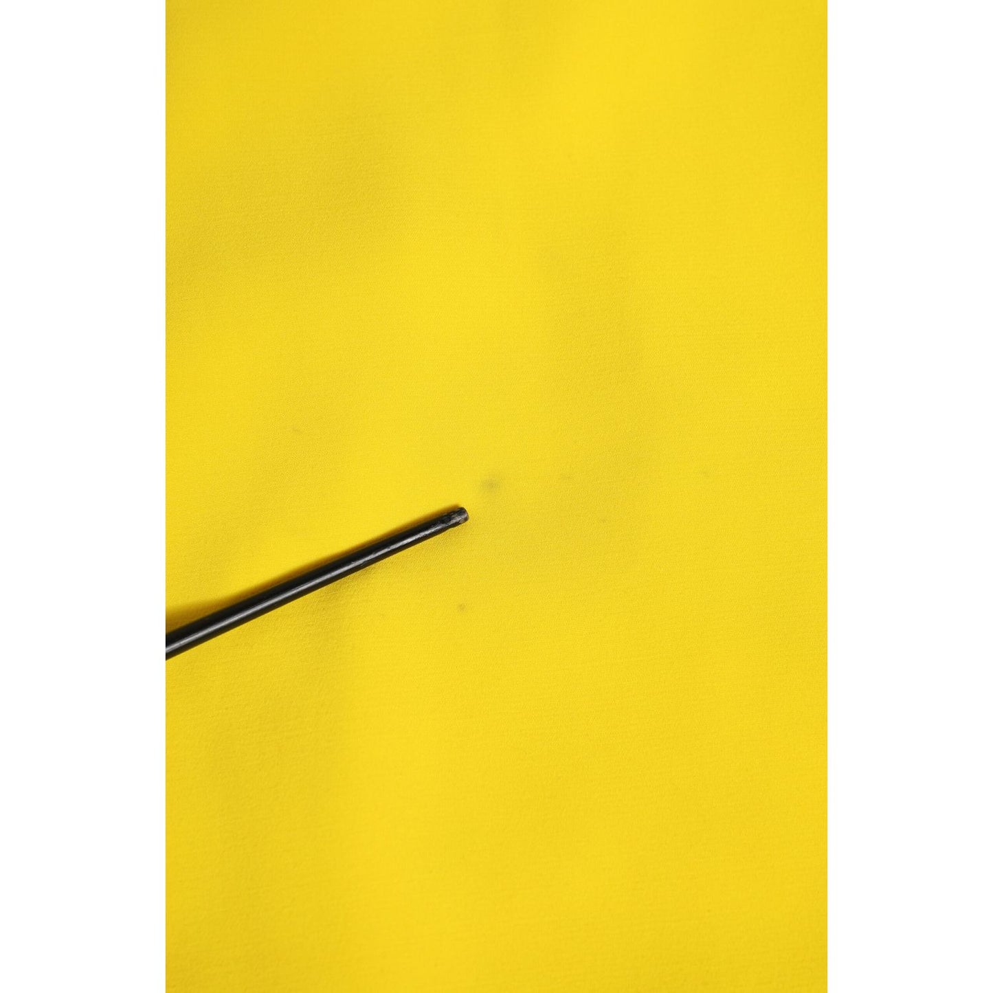 Close-up of fabric detail for Dolce & Gabbana Yellow Polyester Sleeveless Sheath Midi Dress highlighting texture and color.