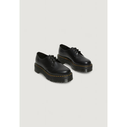 Dr. Martens Black Leather Lace-Up Boots with thick sole, showcasing iconic style and durability for versatile women’s footwear.
