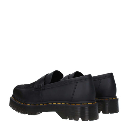 Dr. Martens Black Leather Slip-On Loafers with rubber sole and square toe, casual mid heels, showcasing side and back view.