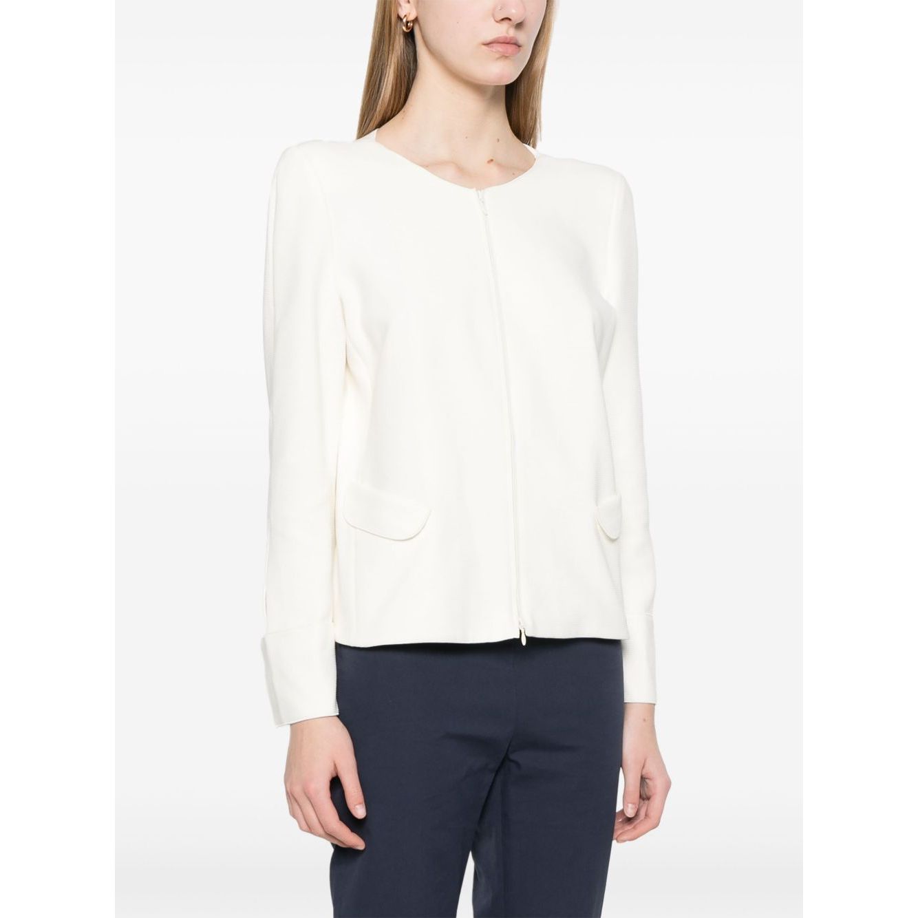 Model wearing white Emporio Armani Ottoman-jersey jacket with zip fastening and shoulder pads, styled with dark trousers.