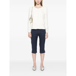 Model wearing Emporio Armani Ottoman-jersey jacket in white with navy pants and silver shoes, featuring a two-way zip fastening and shoulder pads.