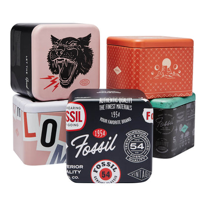 Stack of Fossil vintage design tins with various colorful patterns and logos.