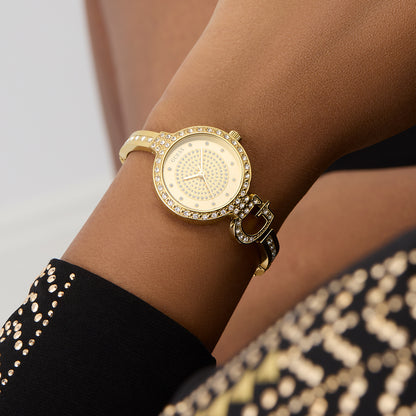 GUESS Mod. GISELLE gold watch on wrist with rhinestone details.