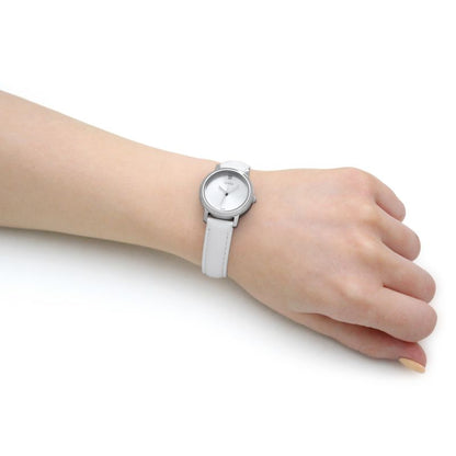 Lady wearing a silver quartz analog watch, 32mm case, 3 ATM water-resistant, GUESS Mod. GW0246L1, showcasing official packaging.