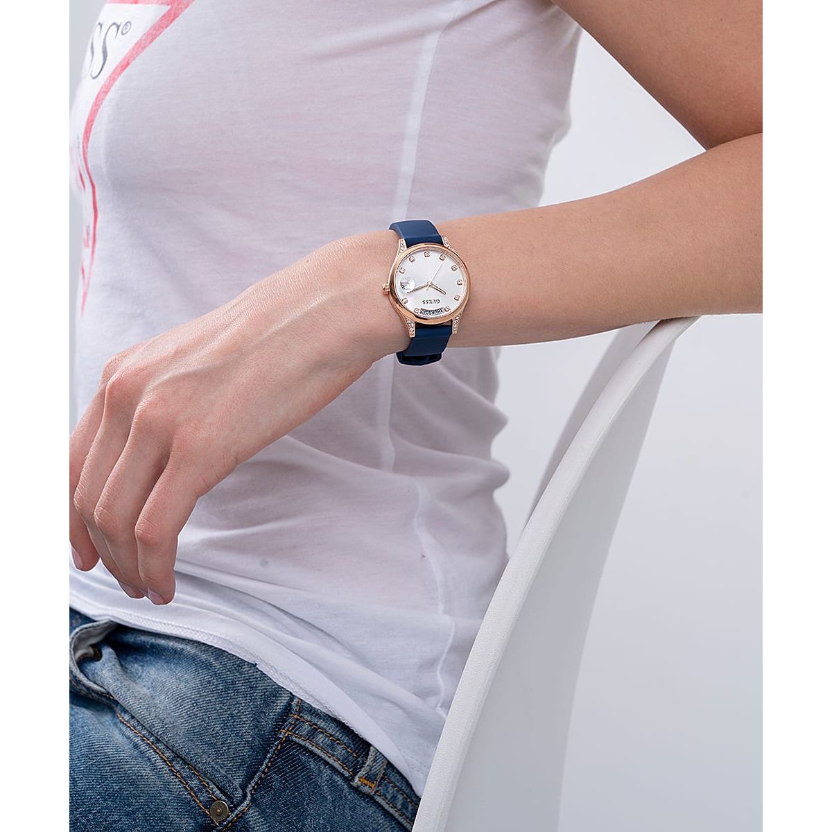 Woman wearing a watch, focusing on GUESS Mod. GW0356L1, featuring a silver case and blue strap, ideal for casual settings.