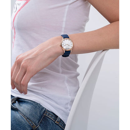 Woman wearing a watch, focusing on GUESS Mod. GW0356L1, featuring a silver case and blue strap, ideal for casual settings.