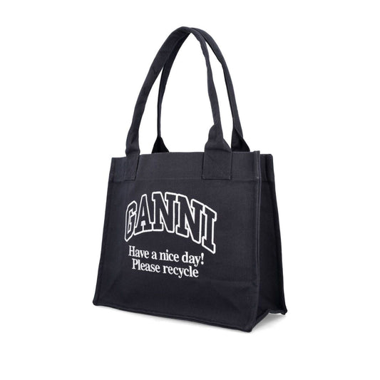 Ganni Organic cotton large tote bag in black with 'Have a nice day! Please recycle' text, featuring two top handles, sustainable fashion accessory.