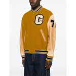 Golden Goose Coats; mustard yellow varsity bomber jacket with leather sleeves, letter patch, ribbed trims, button fastening, welt pockets.