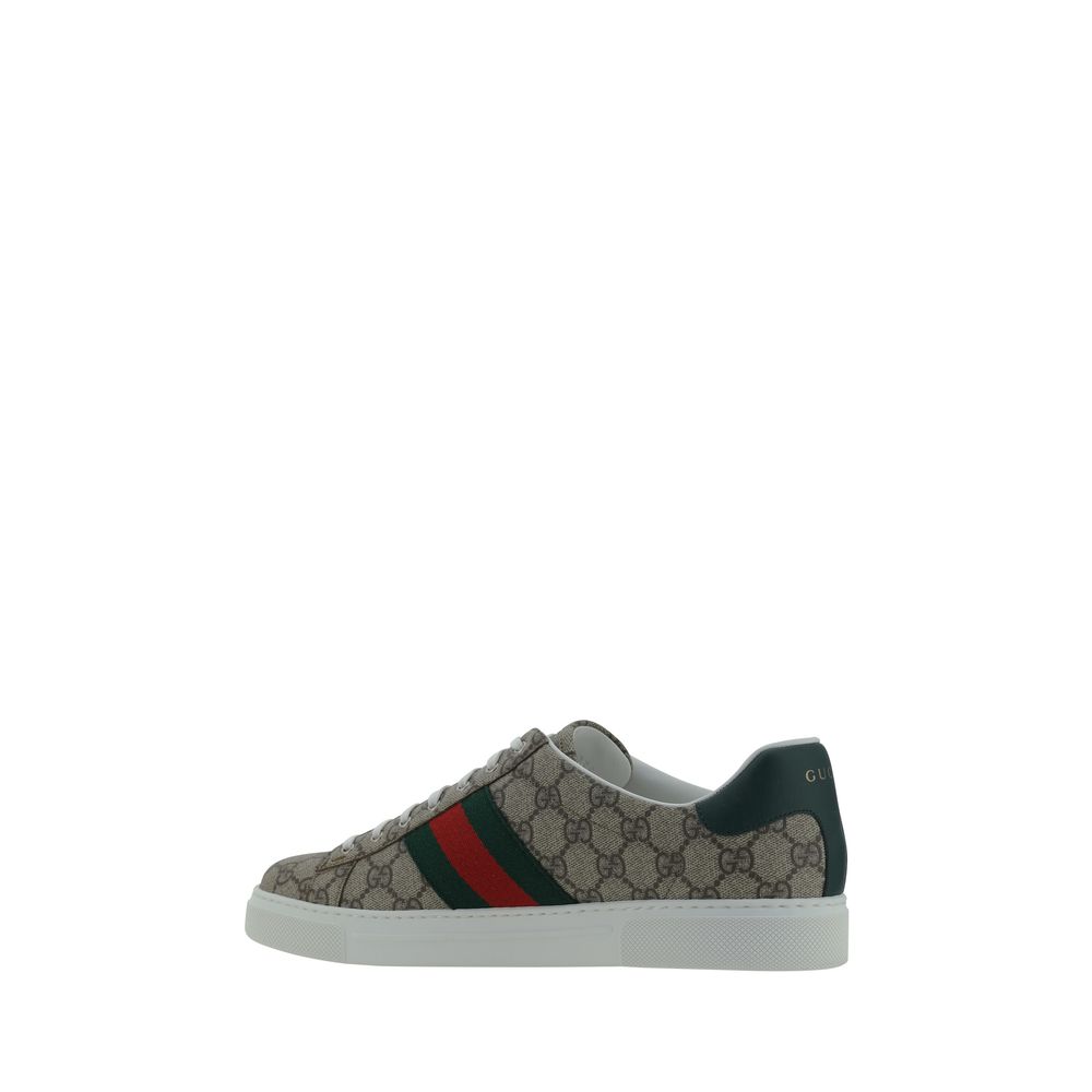 Gucci Beige Rubber Low Top Sneakers with GG jacquard fabric, green-red side bands, leather logo detail, and rubber sole.