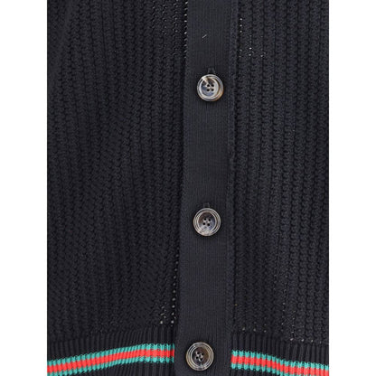 Close-up of Gucci Black Cotton Cardigan showcasing textured knit weave, button closure, and ribbed hem detail.
