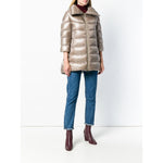 Woman wearing Herno Coats Dove Grey nude feather down padded zipped coat, Cleofe midi style, styled with jeans and boots, front view